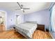 Bedroom features a ceiling fan, wood laminate flooring and a large window at 21562 E 47Th Ave, Denver, CO 80249