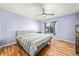 Bedroom with hardwood floors, ceiling fan, and a large window with natural light at 21562 E 47Th Ave, Denver, CO 80249