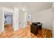 Hallway with wood laminate flooring leading to bedroom and bathroom at 21562 E 47Th Ave, Denver, CO 80249
