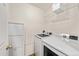 Convenient laundry room equipped with a washer, dryer, and shelving for storage at 21562 E 47Th Ave, Denver, CO 80249