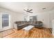 Bright living room featuring wood floors, a gray sectional, and a white coffee table at 21562 E 47Th Ave, Denver, CO 80249