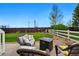 Landscaped backyard with a seating area, fire pit, lush lawn and privacy fencing at 14025 Blue River Trl, Broomfield, CO 80023