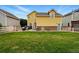 Well-maintained backyard featuring a grill, hot tub and ample grass for outdoor activities at 14025 Blue River Trl, Broomfield, CO 80023