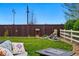 Landscaped backyard featuring a well, rock water feature, and fenced perimeter at 14025 Blue River Trl, Broomfield, CO 80023