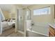 Bright bathroom featuring a shower, tub, and window, offering a relaxing and well-lit space at 14025 Blue River Trl, Broomfield, CO 80023