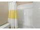Bathroom with a combined shower and tub, featuring a white and yellow shower curtain at 14025 Blue River Trl, Broomfield, CO 80023