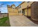 Exterior view of home showing backyard access, basketball hoop, garage and yellow siding at 14025 Blue River Trl, Broomfield, CO 80023