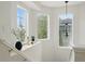 Bright hallway with three windows, natural light, and decorative lighting fixture at 14025 Blue River Trl, Broomfield, CO 80023