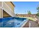 Backyard with a relaxing hot tub and a view of the lush landscaping and blue skies at 14025 Blue River Trl, Broomfield, CO 80023