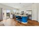 White kitchen with stainless appliances, kitchen island with seating, and sliding doors to a patio at 14025 Blue River Trl, Broomfield, CO 80023