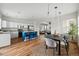 Bright, open kitchen with stainless steel appliances, a blue island with barstool seating and adjacent dining area at 14025 Blue River Trl, Broomfield, CO 80023