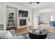 Cozy living room with a fireplace, stylish shelving, and comfortable seating at 14025 Blue River Trl, Broomfield, CO 80023