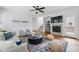 Inviting living room featuring a fireplace, ceiling fan, hardwood floors, and stylish decor at 14025 Blue River Trl, Broomfield, CO 80023