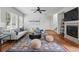 Bright living room with large windows, stylish furniture, and a cozy fireplace with a flatscreen TV at 14025 Blue River Trl, Broomfield, CO 80023