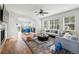 Open-concept living area with hardwood floors, fireplace, and connected kitchen and dining spaces at 14025 Blue River Trl, Broomfield, CO 80023