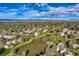 Beautiful aerial view of homes surrounding a tranquil pond in a scenic community with lush landscaping at 4273 W Ponds Cir, Littleton, CO 80123