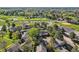 This aerial showcases the property with a golf course, lake, and mature trees in a park-like setting at 4273 W Ponds Cir, Littleton, CO 80123