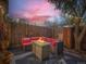 Cozy patio with comfortable seating and a fire pit under string lights, perfect for outdoor relaxation at 4273 W Ponds Cir, Littleton, CO 80123