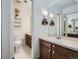 Updated bathroom with double vanity, granite countertop, large mirror and modern fixtures at 4273 W Ponds Cir, Littleton, CO 80123