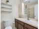 Functional bathroom featuring a vanity with storage, a sink, and a shower behind a glass door at 4273 W Ponds Cir, Littleton, CO 80123