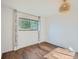 Light-filled bedroom features wood flooring, large window, and modern light fixture at 4273 W Ponds Cir, Littleton, CO 80123