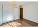 Neat bedroom with wood floors, a closet with sliding doors, and bright walls at 4273 W Ponds Cir, Littleton, CO 80123