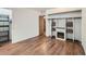 Bright bedroom featuring hardwood floors, custom closet with shelves, and electric fireplace at 4273 W Ponds Cir, Littleton, CO 80123