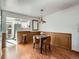 Dining area with wooden table, chairs, and easy access to the adjacent kitchen at 4273 W Ponds Cir, Littleton, CO 80123
