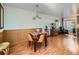 Elegant dining area featuring a wooden table, stylish chairs, and hardwood floors at 4273 W Ponds Cir, Littleton, CO 80123