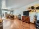 Open dining area with hardwood floors, pendant lighting, and adjacent kitchen view at 4273 W Ponds Cir, Littleton, CO 80123