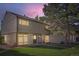 Charming townhome with a well-maintained lawn and appealing exterior features at dusk at 4273 W Ponds Cir, Littleton, CO 80123