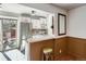 Bright kitchen featuring stainless steel refrigerator, white cabinets and tile backsplash at 4273 W Ponds Cir, Littleton, CO 80123
