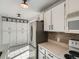 Well-lit kitchen featuring ample cabinetry, stainless steel appliances, and tile flooring at 4273 W Ponds Cir, Littleton, CO 80123