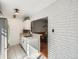Bright kitchen features white cabinets, tile flooring, modern lighting, and access to the dining room at 4273 W Ponds Cir, Littleton, CO 80123
