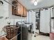 Functional laundry room equipped with modern washer and dryer, cabinetry, and ample storage space at 4273 W Ponds Cir, Littleton, CO 80123