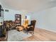 Cozy living room featuring hardwood floors, a fireplace with stacked wood, and a comfortable seating area at 4273 W Ponds Cir, Littleton, CO 80123