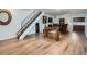 Inviting living room with wood floors, fireplace, staircase, and comfortable seating, perfect for relaxation and entertaining at 4273 W Ponds Cir, Littleton, CO 80123