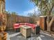 Outdoor patio with comfortable seating, a fire pit, and string lights, perfect for enjoying sunny days at 4273 W Ponds Cir, Littleton, CO 80123