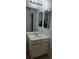 Bathroom with a vanity and sink underneath a lighted mirror at 5319 Morning Glory Pl, Highlands Ranch, CO 80130