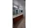 Double sink vanity with tile flooring and a walk-in shower at 5319 Morning Glory Pl, Highlands Ranch, CO 80130