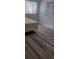 Bedroom featuring newer gray laminate flooring and two windows at 5319 Morning Glory Pl, Highlands Ranch, CO 80130