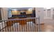 Open kitchen featuring wood cabinets, black countertops, and stainless steel appliances, seamlessly integrated with the home's layout at 5319 Morning Glory Pl, Highlands Ranch, CO 80130