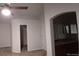 Bright main bedroom featuring vaulted ceilings, neutral paint, and carpet. Arched doorway leads to bathroom at 5319 Morning Glory Pl, Highlands Ranch, CO 80130
