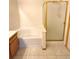 Bright bathroom featuring a tub with tile surround and a glass shower door for a clean and modern look at 3231 E 102Nd Pl, Thornton, CO 80229