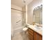 Bright bathroom features a shower-tub combination, ceramic tile, and a wooden vanity with sink at 3231 E 102Nd Pl, Thornton, CO 80229