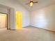 Neutral carpet, a fan, and a doorway to the bathroom, create a spacious and welcoming retreat at 3231 E 102Nd Pl, Thornton, CO 80229