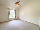 Bright bedroom features neutral carpet, vaulted ceiling, and natural light from the large window at 3231 E 102Nd Pl, Thornton, CO 80229