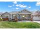 Inviting single-story home featuring a charming front porch and a well-manicured lawn at 3231 E 102Nd Pl, Thornton, CO 80229