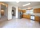 Bright kitchen with light wood cabinets, stainless steel appliances, and easy access to the living area at 3231 E 102Nd Pl, Thornton, CO 80229