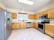 Well-lit kitchen featuring stainless steel appliances and light wood cabinets at 3231 E 102Nd Pl, Thornton, CO 80229